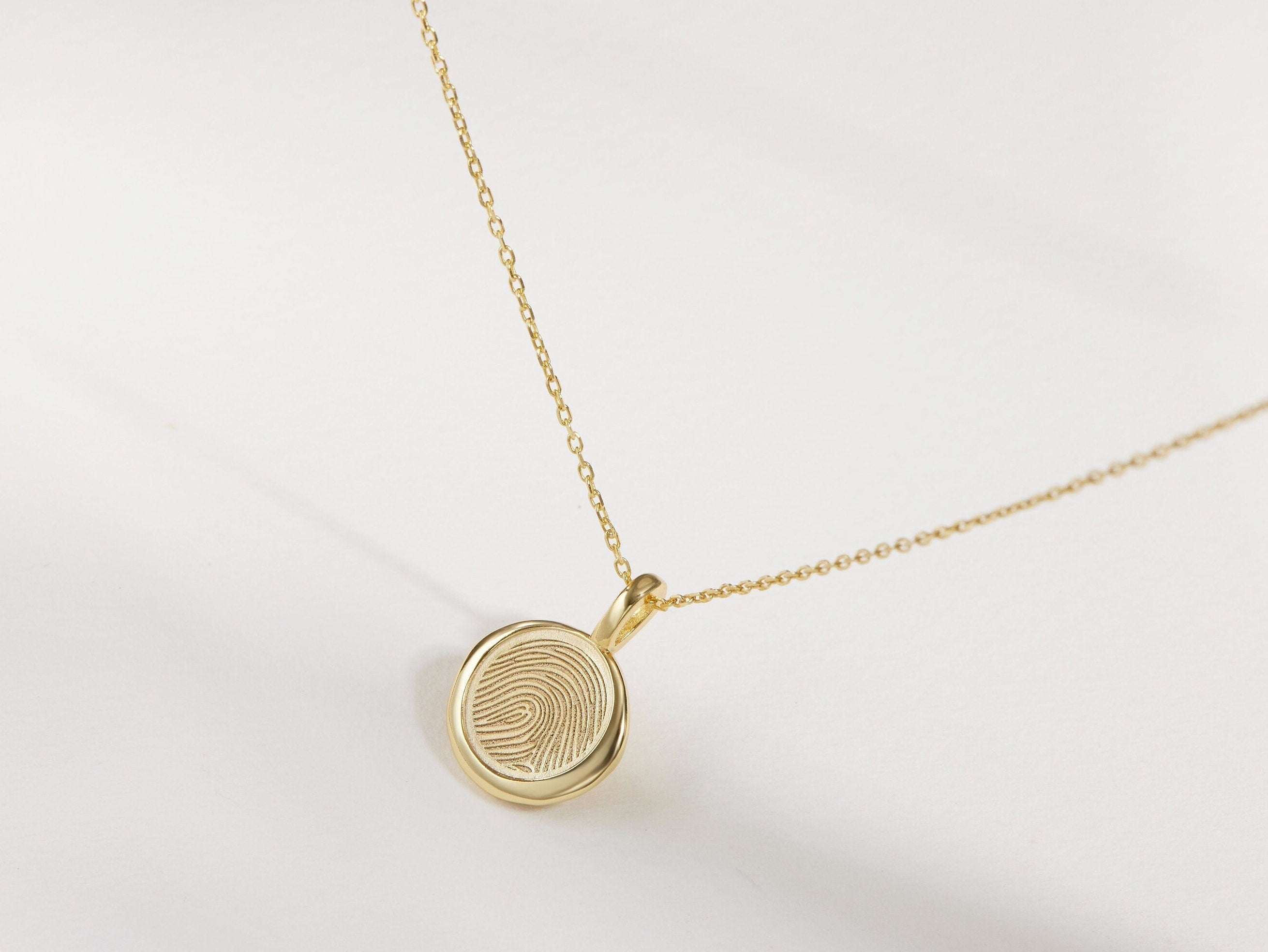 Round personalized fingerprint necklace with engraved ridge pattern