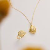 two pieces of gold jewelry: a ring and a necklace.