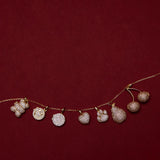 Necklace with paw print and heart pendants on a red background