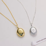 Two necklaces with locket pendants on a light gray background