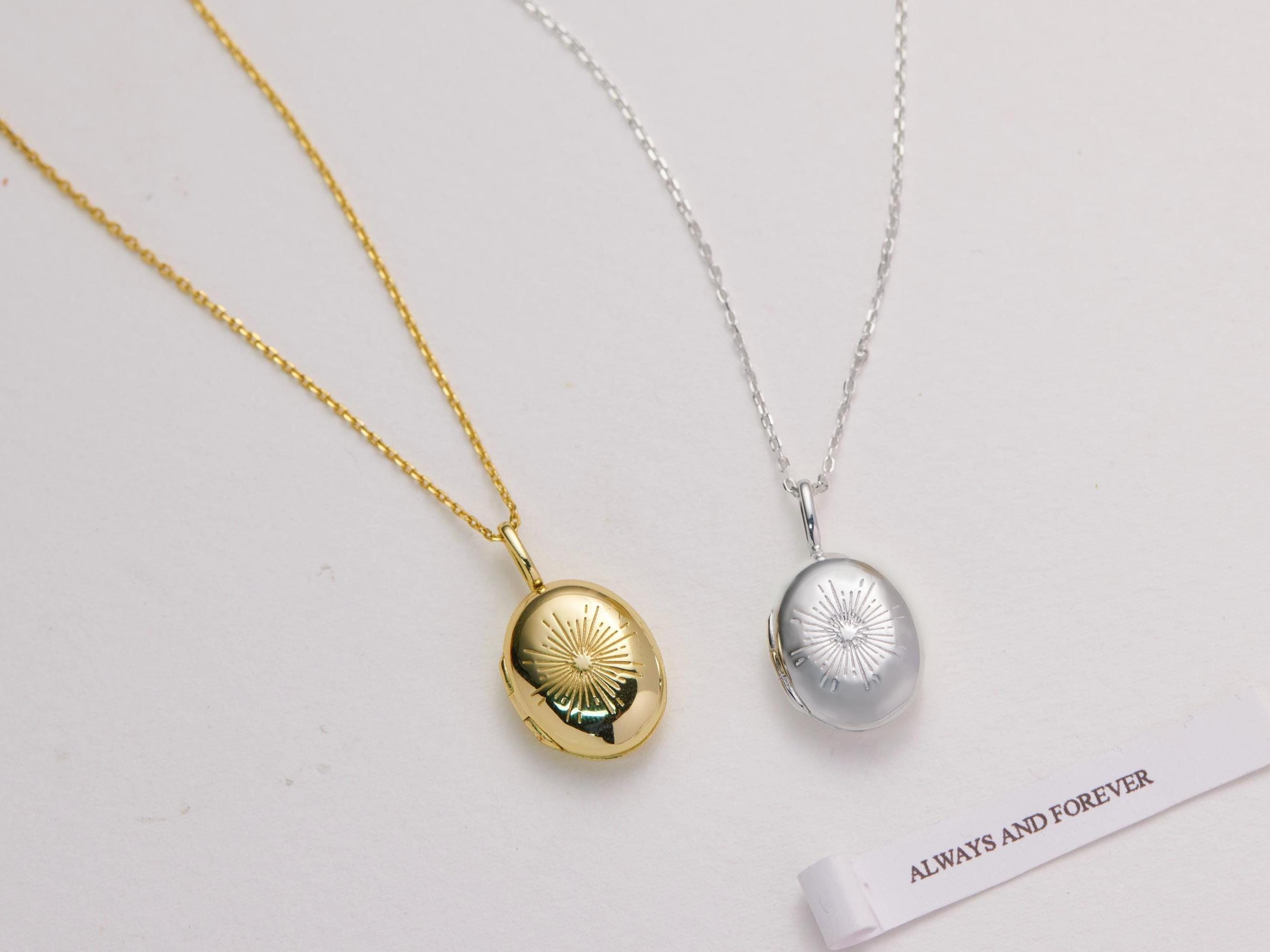 Two necklaces with locket pendants on a light gray background