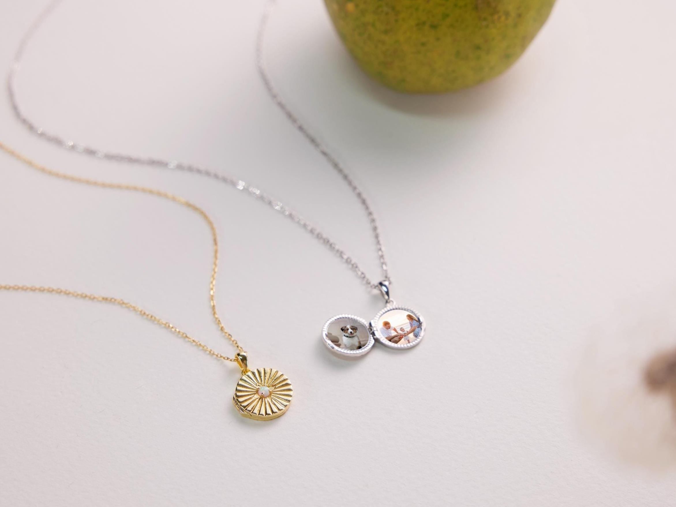 Two necklaces on a light surface with a blurred background