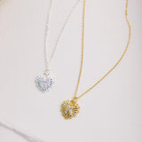 Two necklaces with pendants on a light background