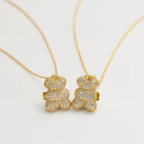 Gold teddy bear necklaces on a white background
