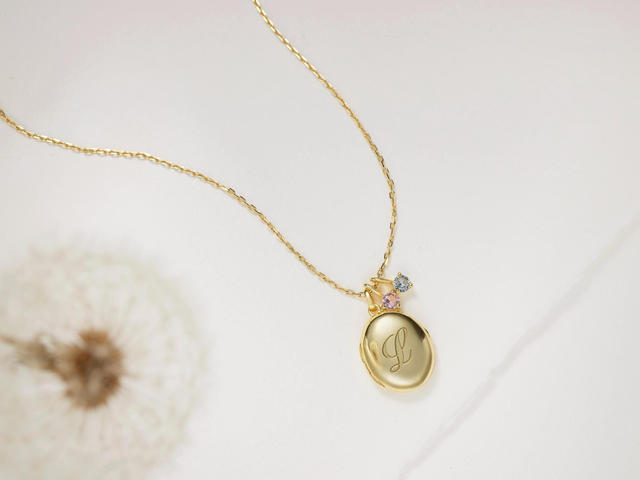 Gold necklace with a pendant on a light background