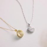 Two necklaces with circular pendants on a light background